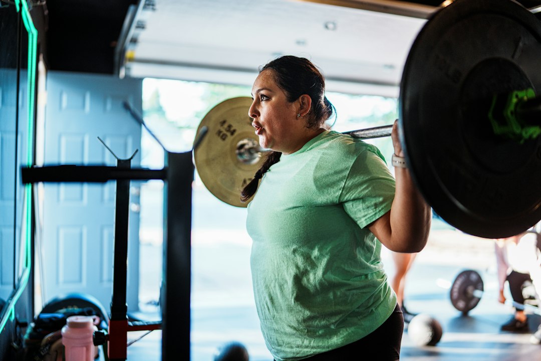 Illustrative stock photo: Woman lifting weights in a gym