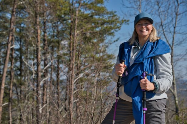 Woman hiking with trekking poles on a woodland trail