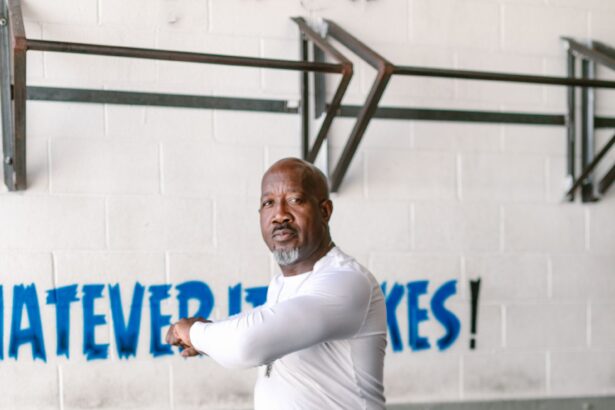 Man warming up with a stretch in a gym