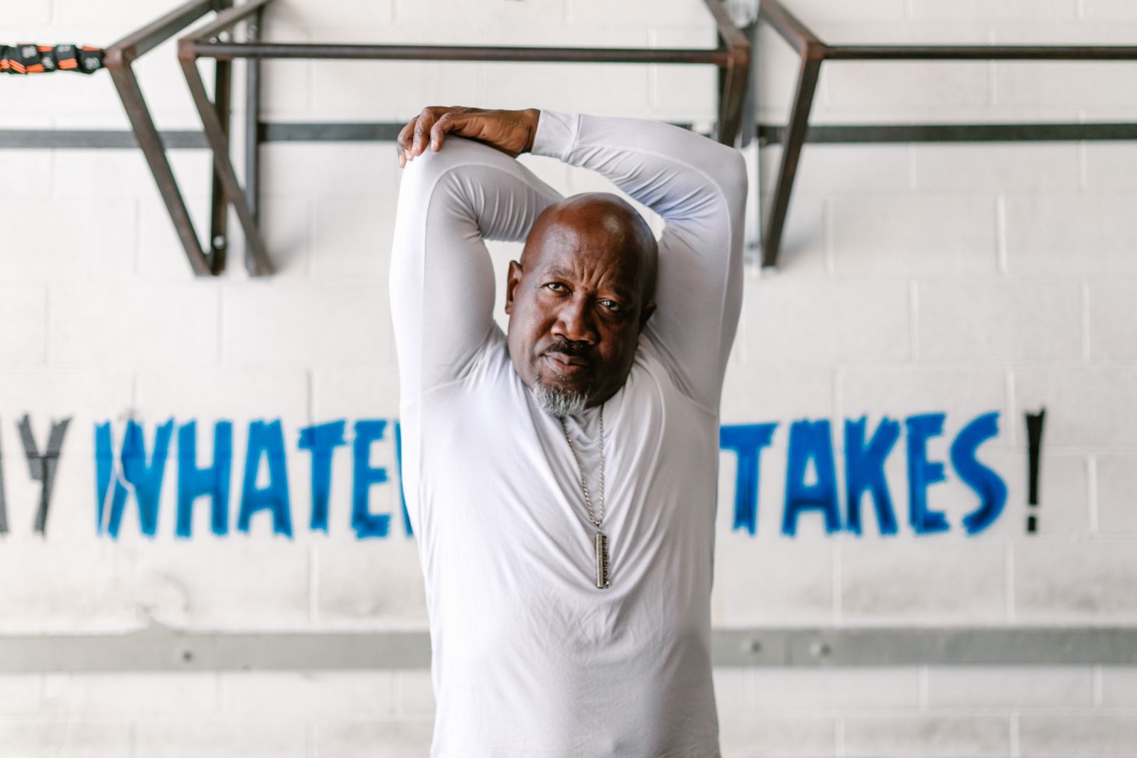 Man stretching his arm before a gym workout