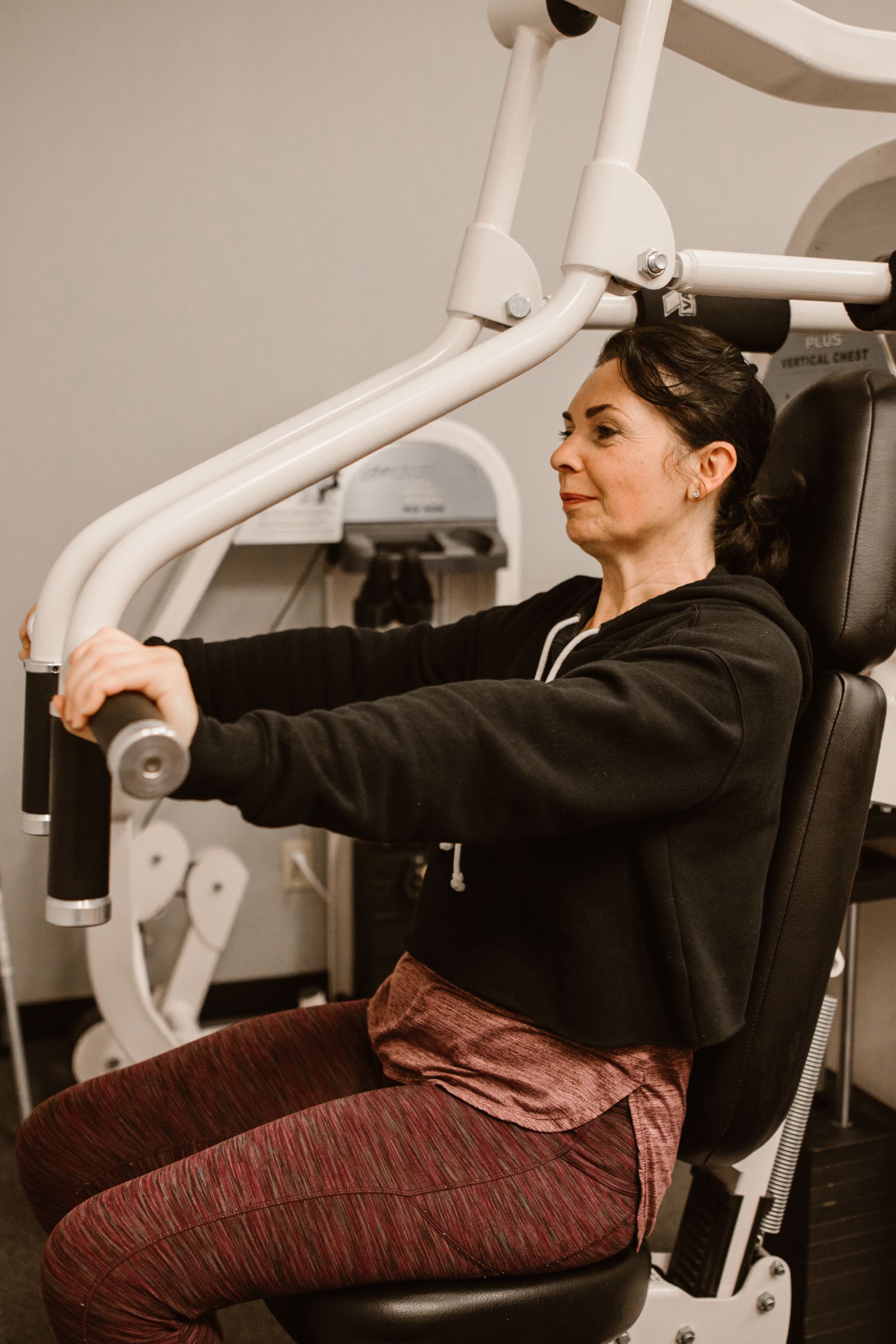 Woman working out on a resistance machine in a gym